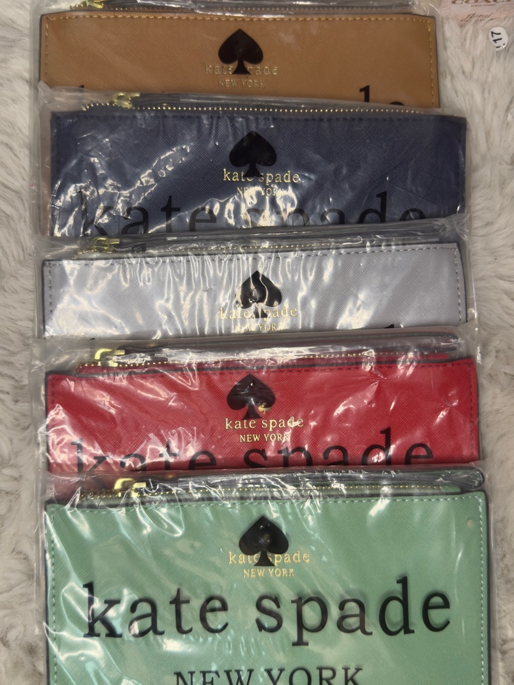 kate spade slim zip pouches in tan, navy, light gray, red, mint